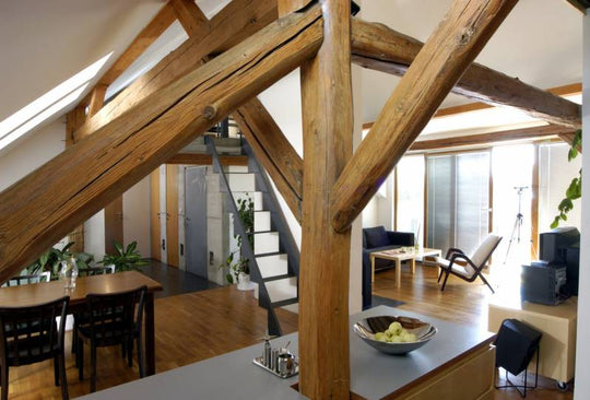 Exposed wooden beams in the middle of a modern kitchen. 