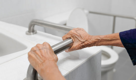 elderly hands holding a support railing