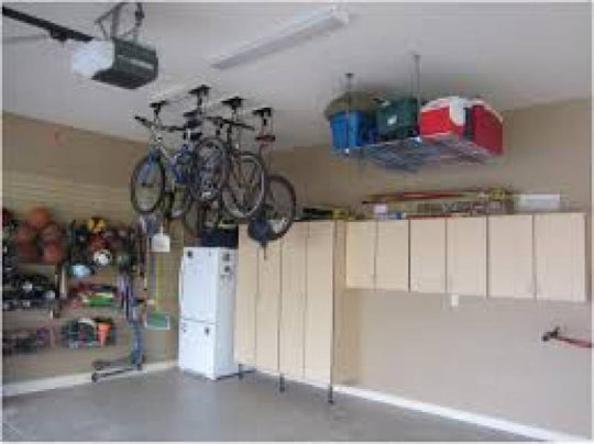 Interior of clean garage. Storage racks for bikes, totes and sports equipment. 