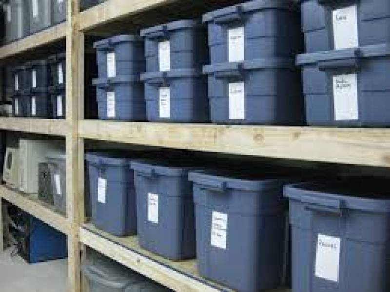 Selves of plastic bins lined up for storage.