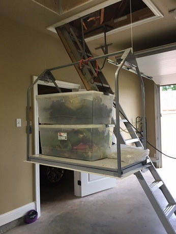 Stairlift being used to access a loft with storage boxes inside.